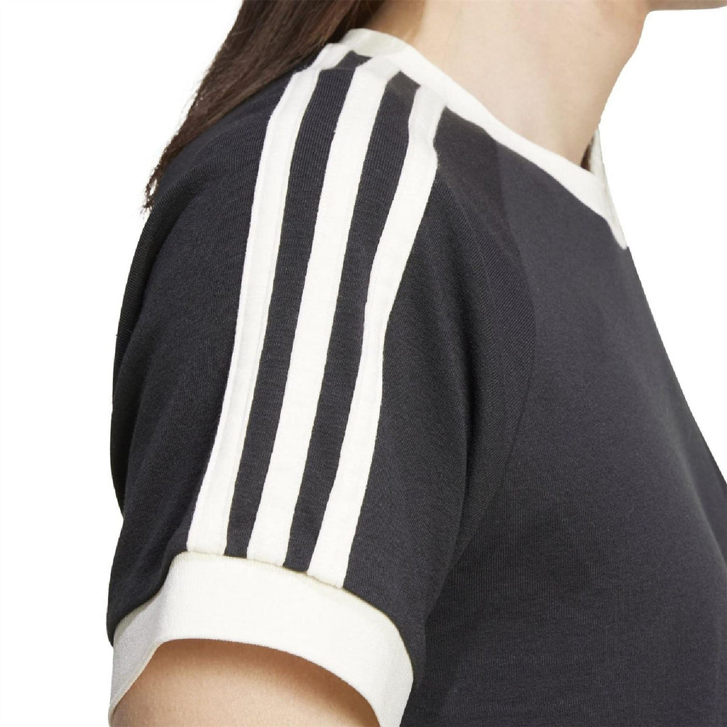 Black adidas T-shirt shoulder detail with bold three white vertical sleeve stripes