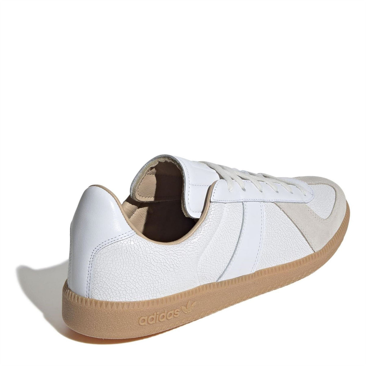 White adidas sneakers with beige interior lining, lace-up design, and gum rubber sole