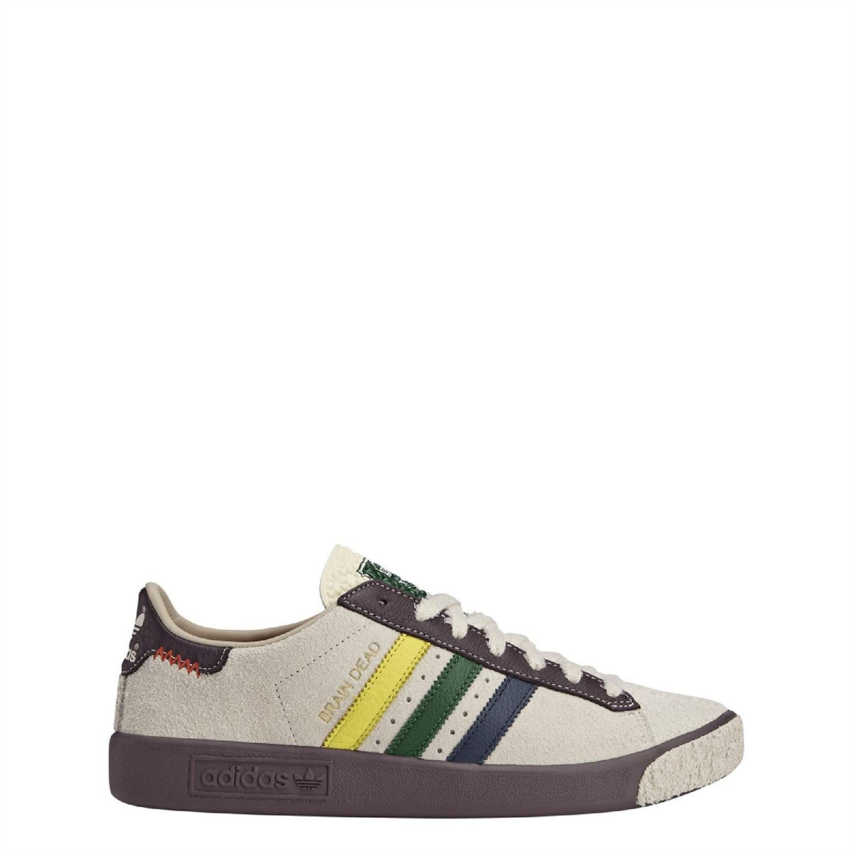 Cream low-top sneakers with navy, green and yellow stripes, brown sole