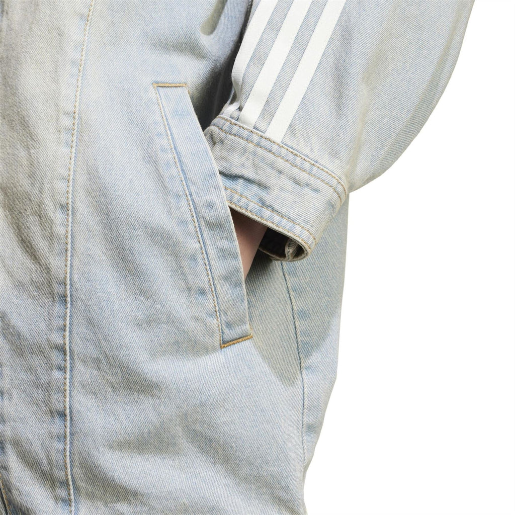 adidas Originals light denim jacket cuff detail with vertical stripe panel and button closure