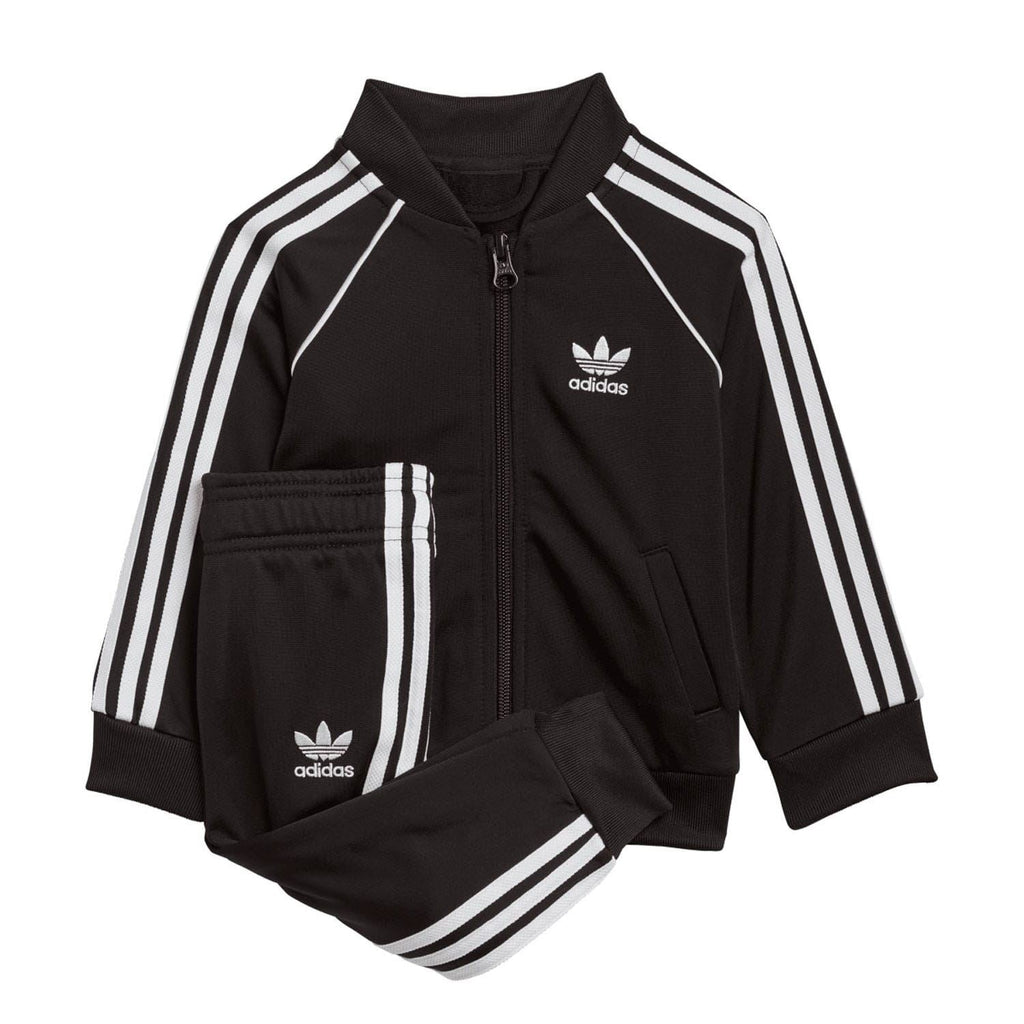 Infant black zip-up tracksuit jacket with white triple stripes, adidas logo, and matching pants
