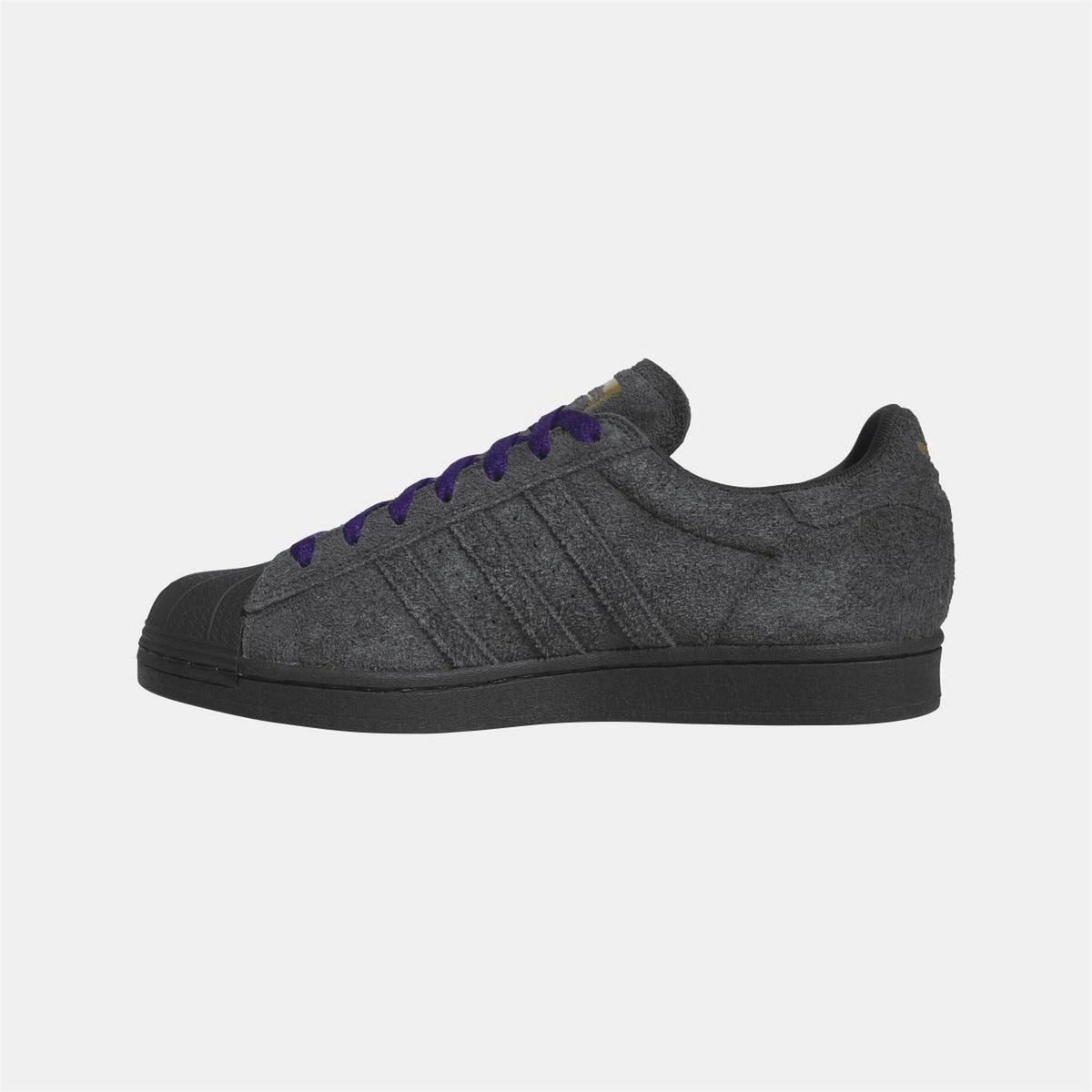 Black low-top sneakers with purple laces, side stripes, and textured toe cap