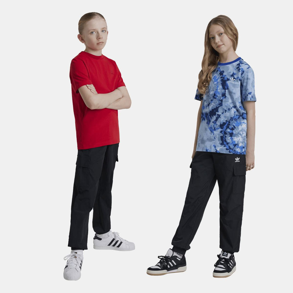 Junior black cargo track pants worn with sneakers, elastic waist and cuffed leg openings