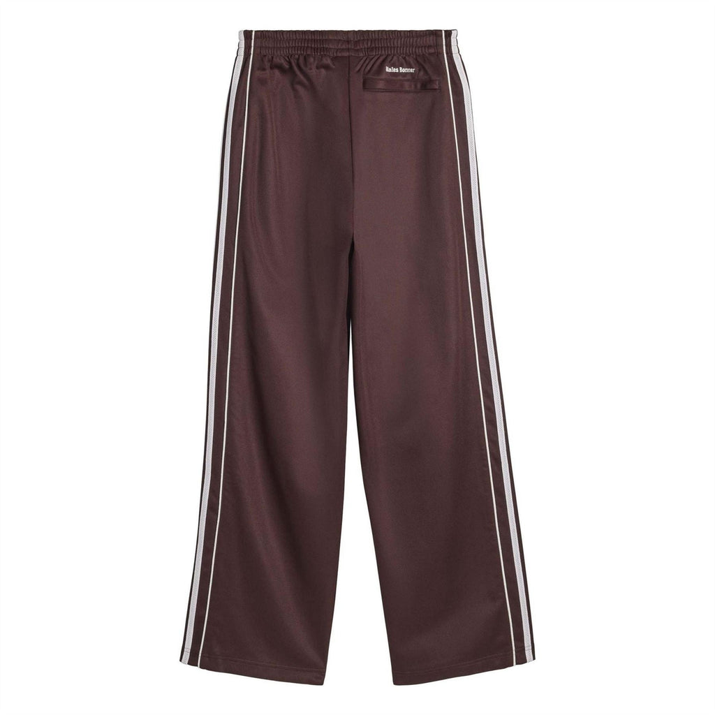 Track pants in dark maroon with white side stripes and small adidas logo at waist.