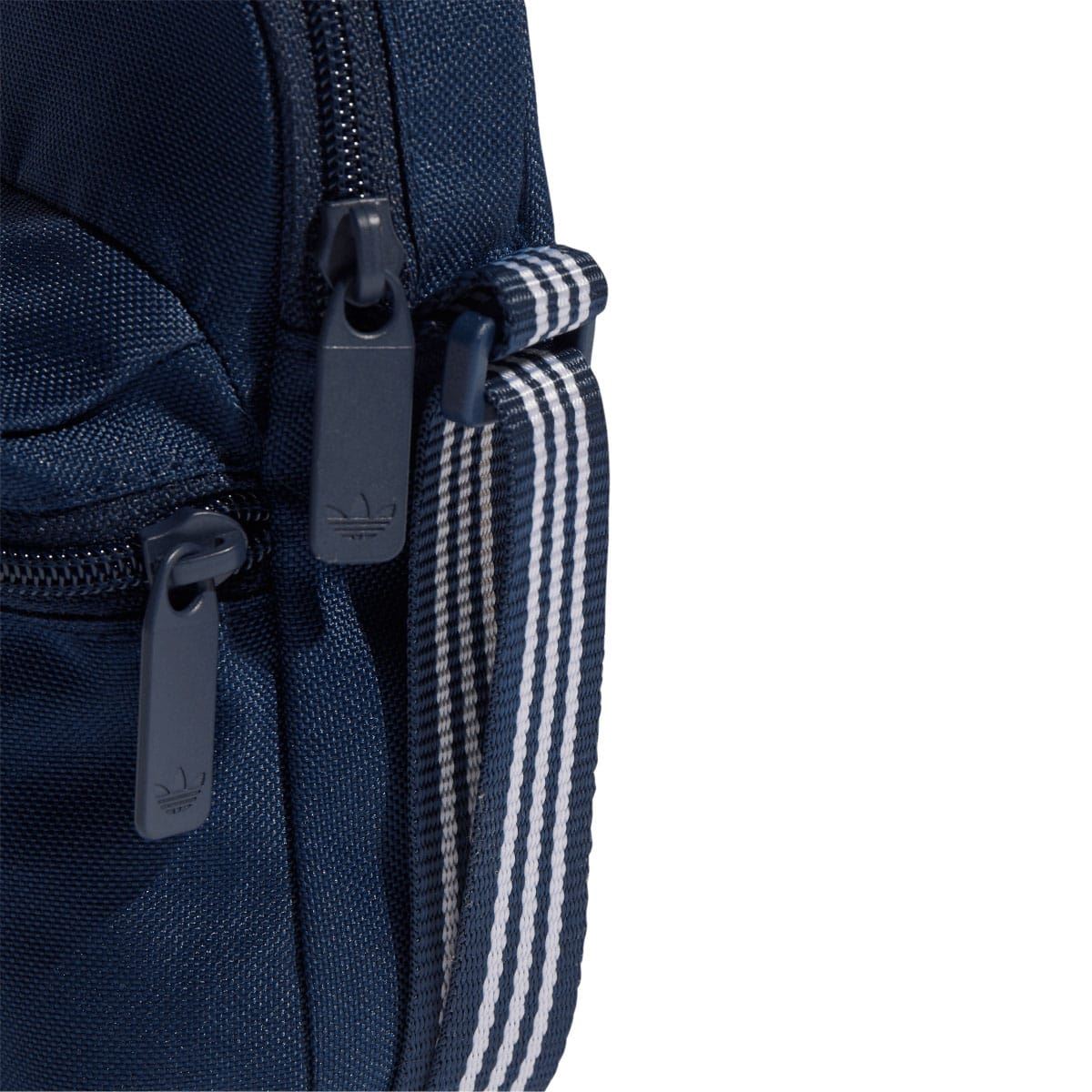 Navy bag with striped adjustable strap and black zipper pulls