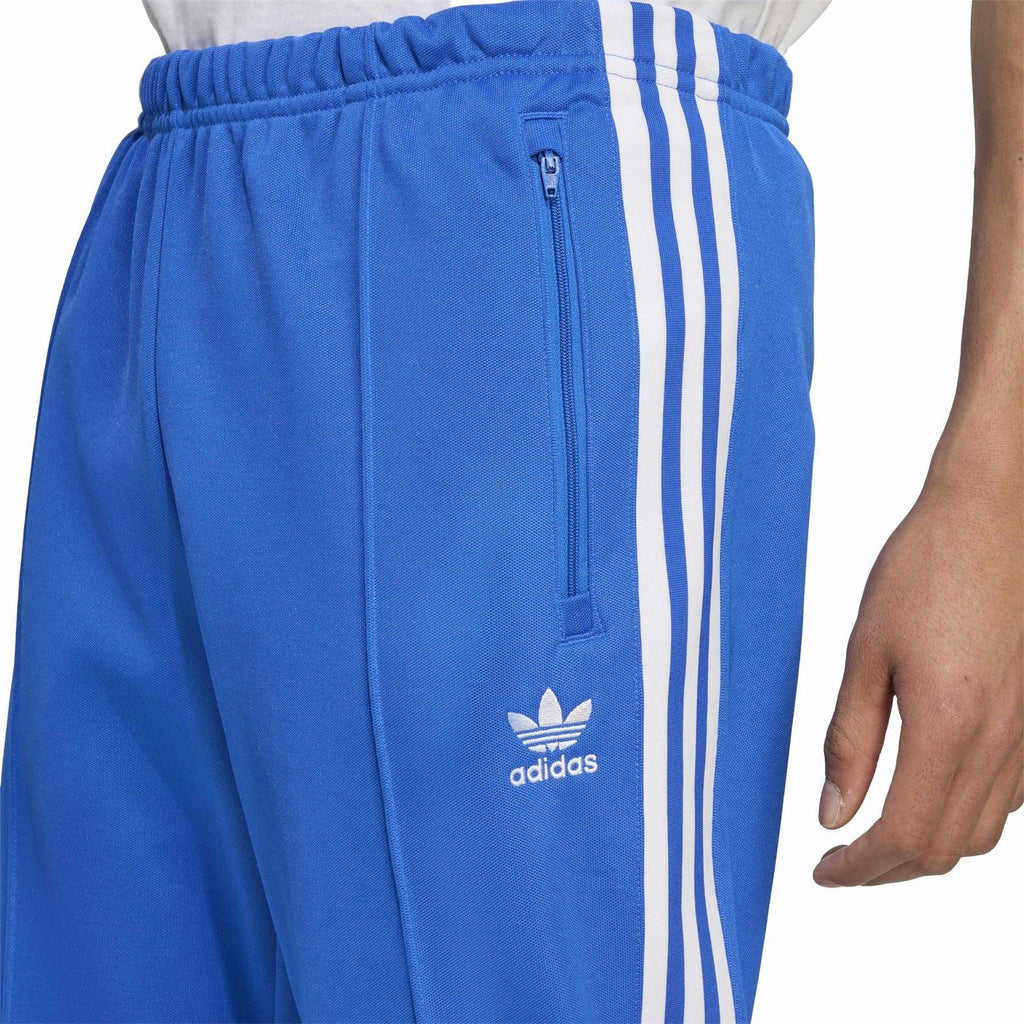 Blue track pants with elastic waist, adidas logo, and white triple stripe down leg