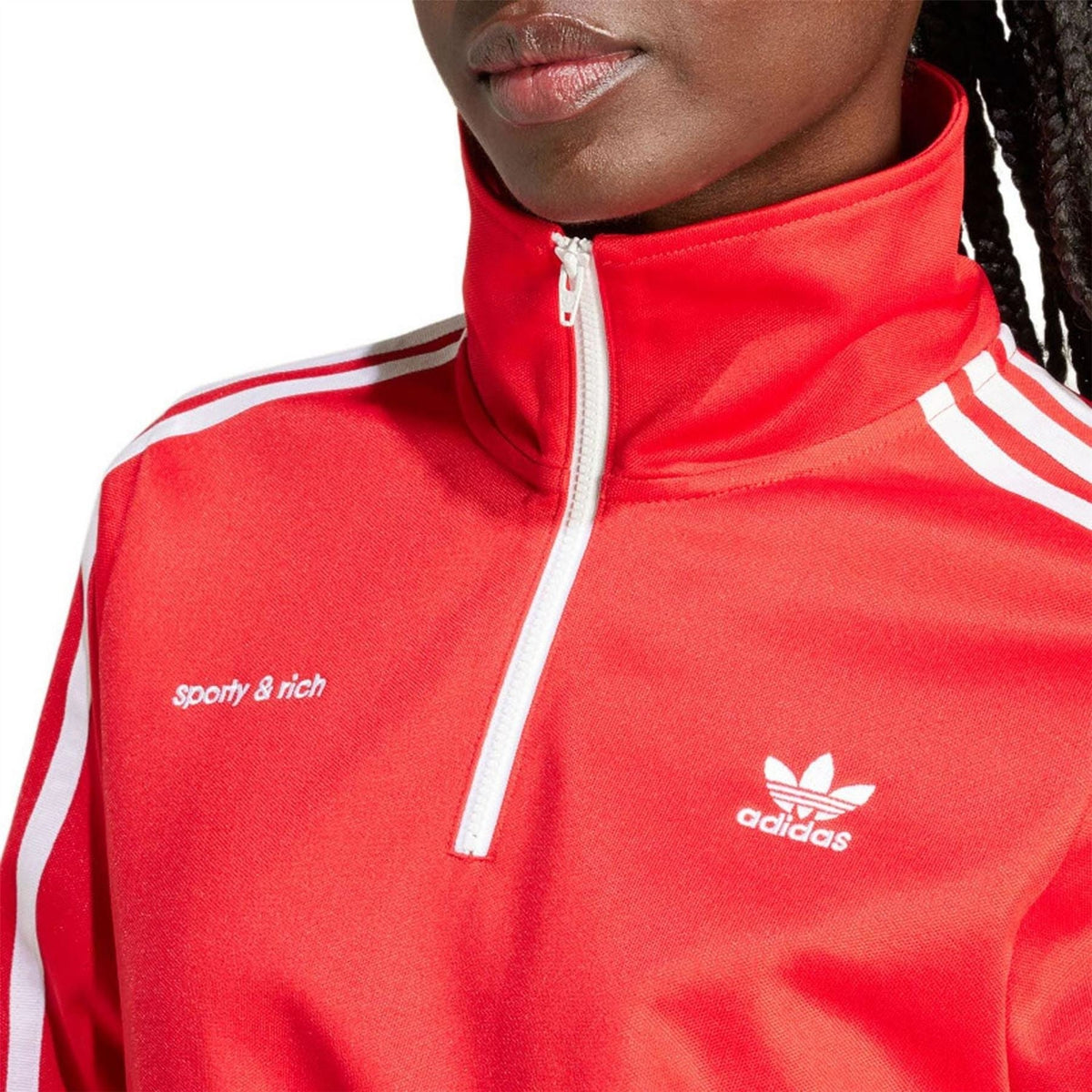 Red track top close-up with quarter-zip collar, “sporty & rich” text and adidas logo