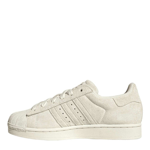 Light cream suede Adidas Originals-style low-top sneakers, side view with three stripes