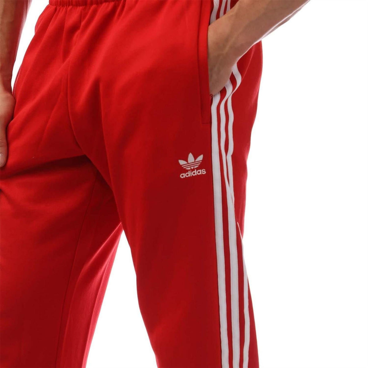 Red adidas track pants with trefoil logo and white side stripe panel