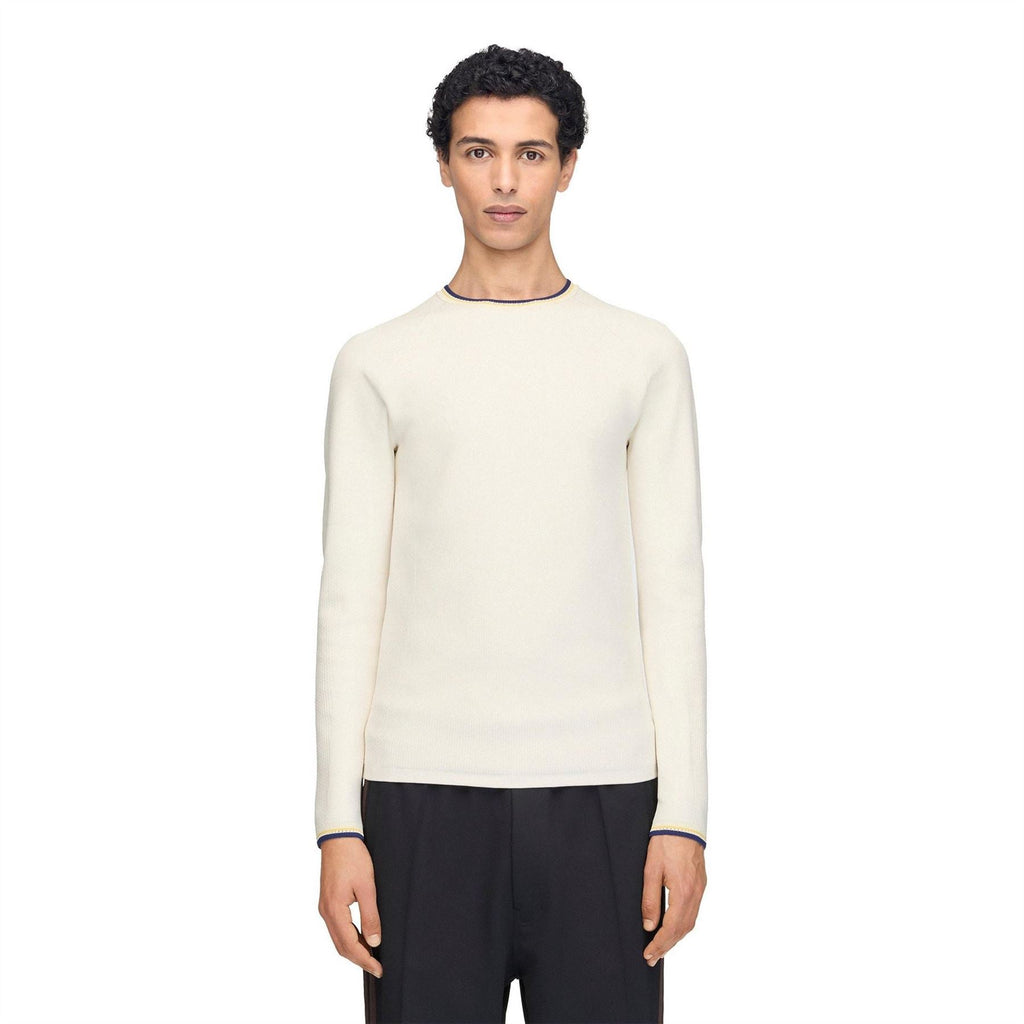 Cream knit long-sleeve crewneck top with navy and yellow cuff trim