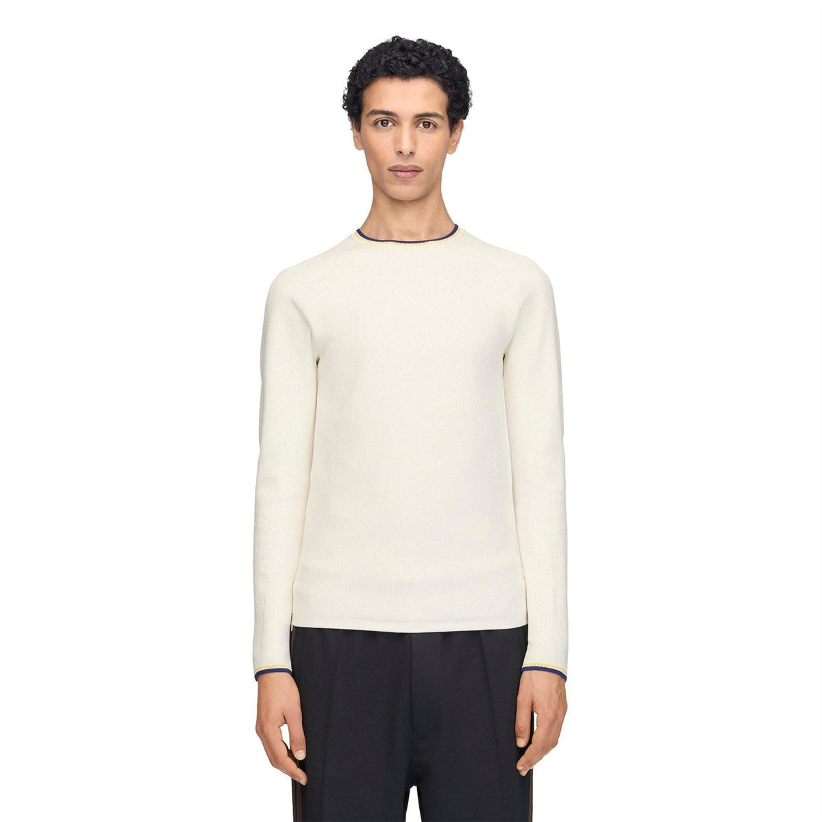 Cream knit long-sleeve crewneck top with navy and yellow cuff trim