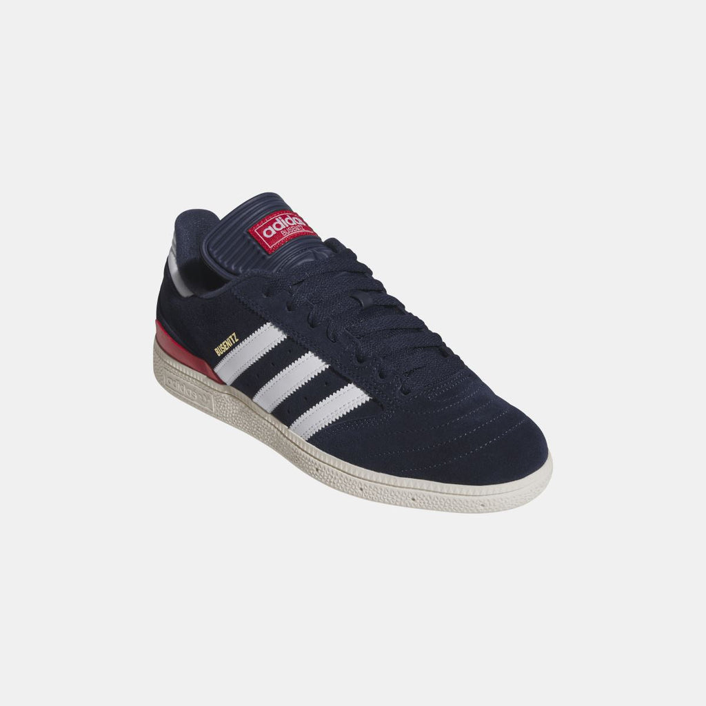 Navy Busenitz sneakers with collar strap, white stripes, and red midsole edge