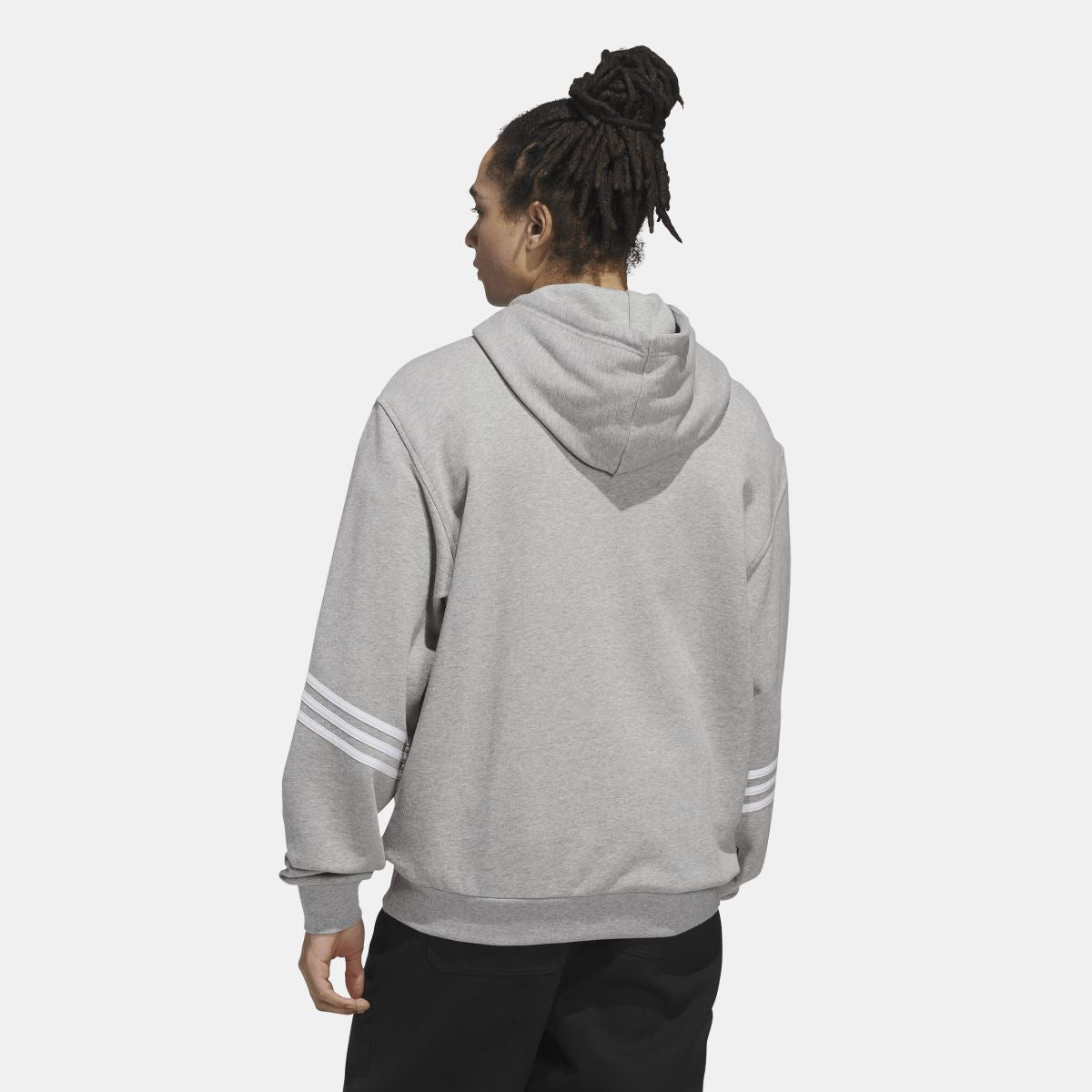 Grey adidas Originals hoodie on model from back with drawstring hood and sleeve stripes.