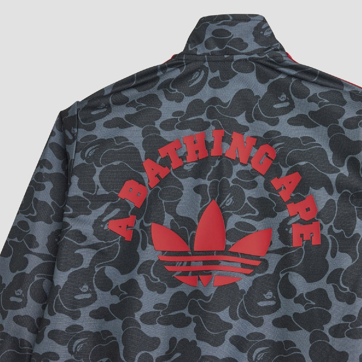 Camo jacket back with bold red 'BATHING APE' text graphic and trefoil logo