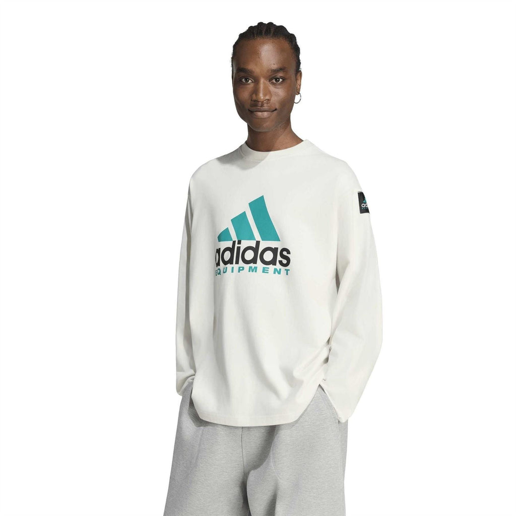 Off-white long-sleeve top with teal adidas Equipment logo and crew neckline