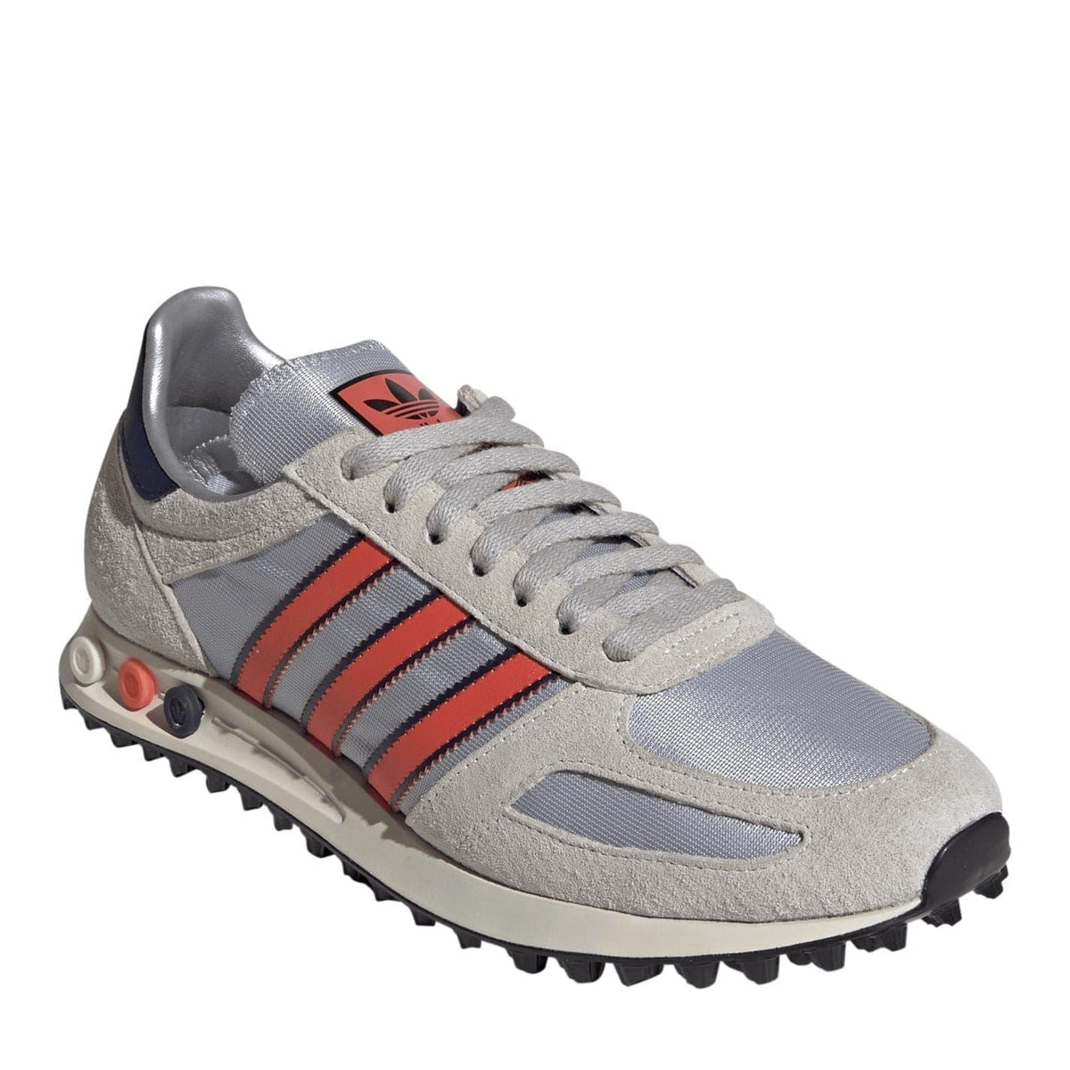 Grey lace-up sneakers with red, white, and navy accents, side stripes, chunky tread sole