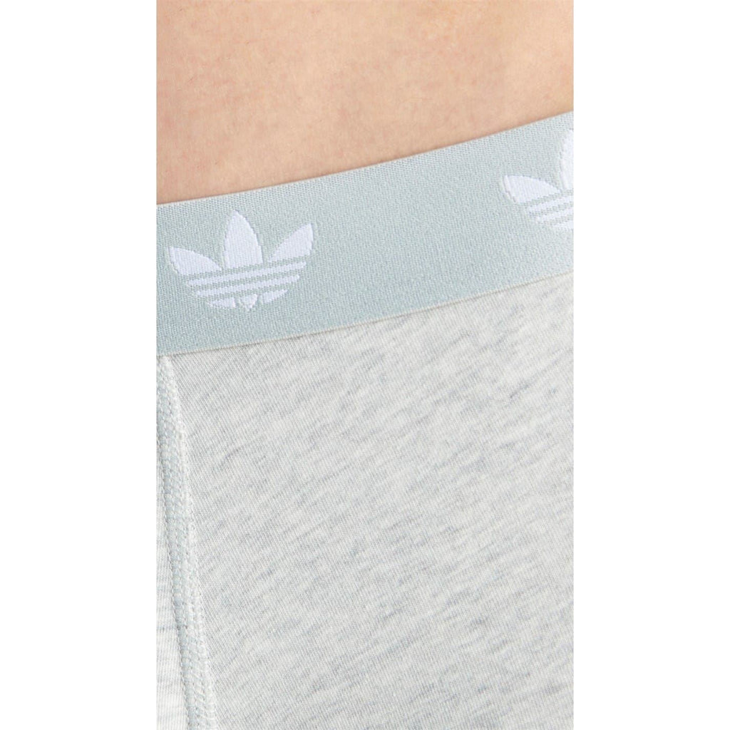 Close-up of light grey adidas logo boxer waistband with repeating trefoil pattern