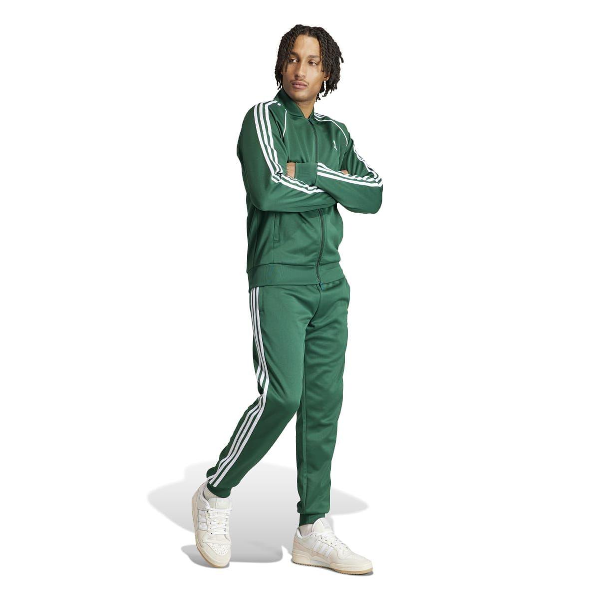 Green adidas track jacket on model with full zip front and white three-stripe sleeves