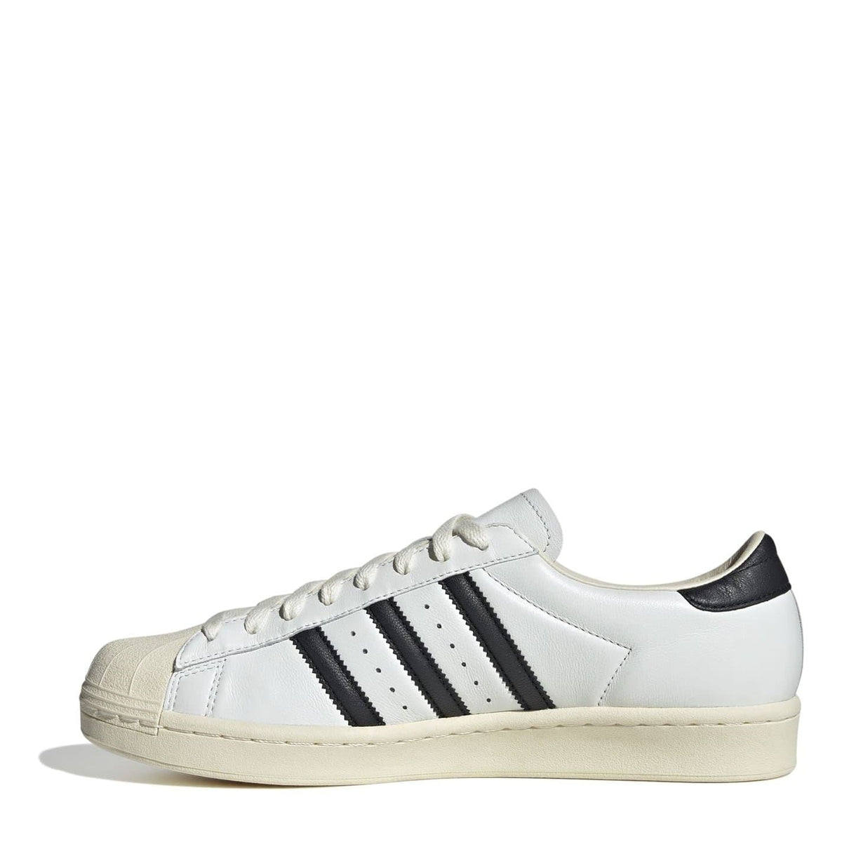 White low-top sneakers with black side stripes, lace-up, beige sole