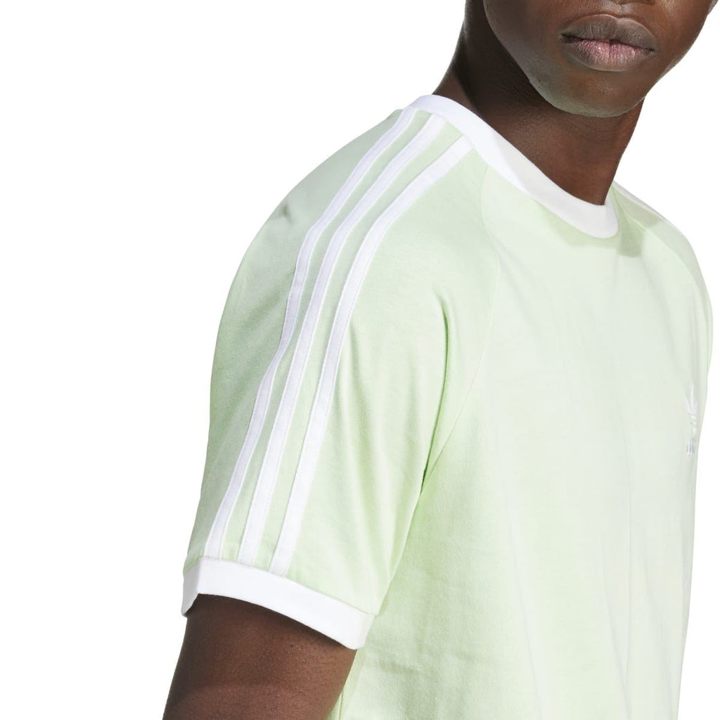 Light green adidas Originals T-shirt sleeve close-up with 3-stripe detail