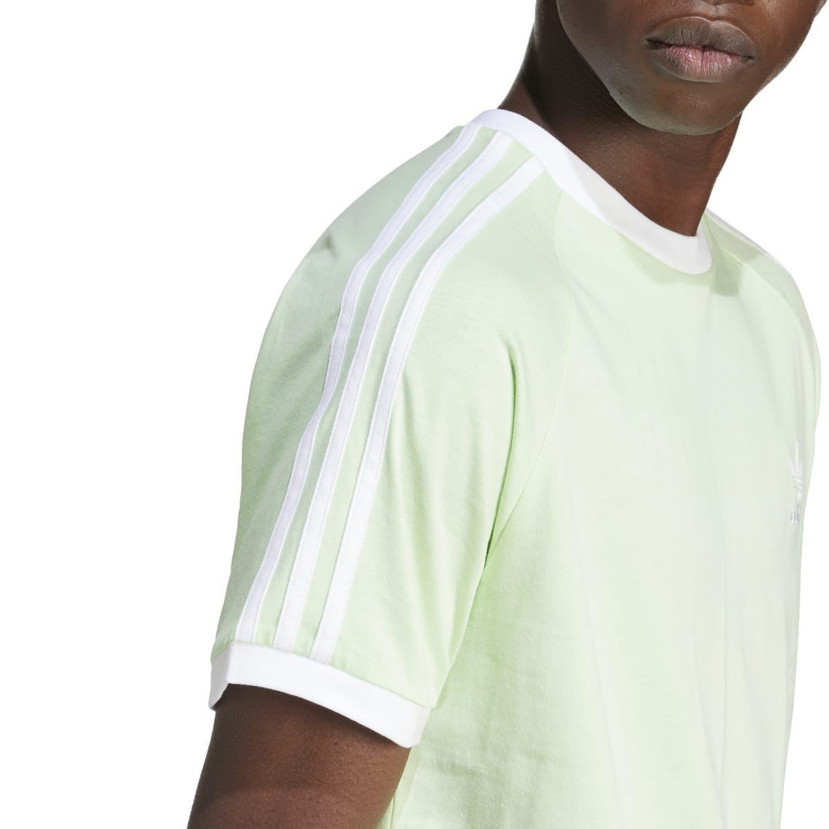 Light green adidas Originals T-shirt sleeve close-up with 3-stripe detail