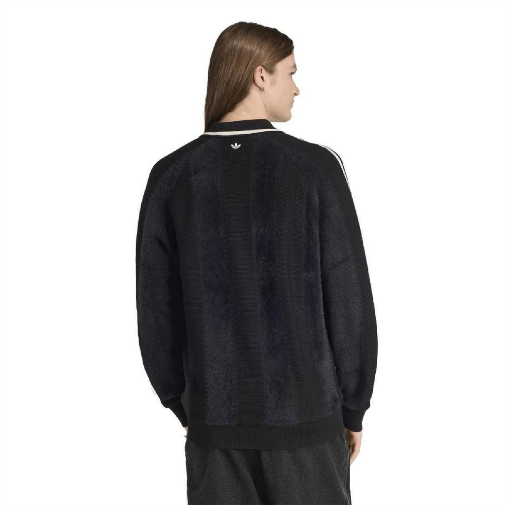 Back view of dark collared raglan sweater with white side stripe bands on sleeves