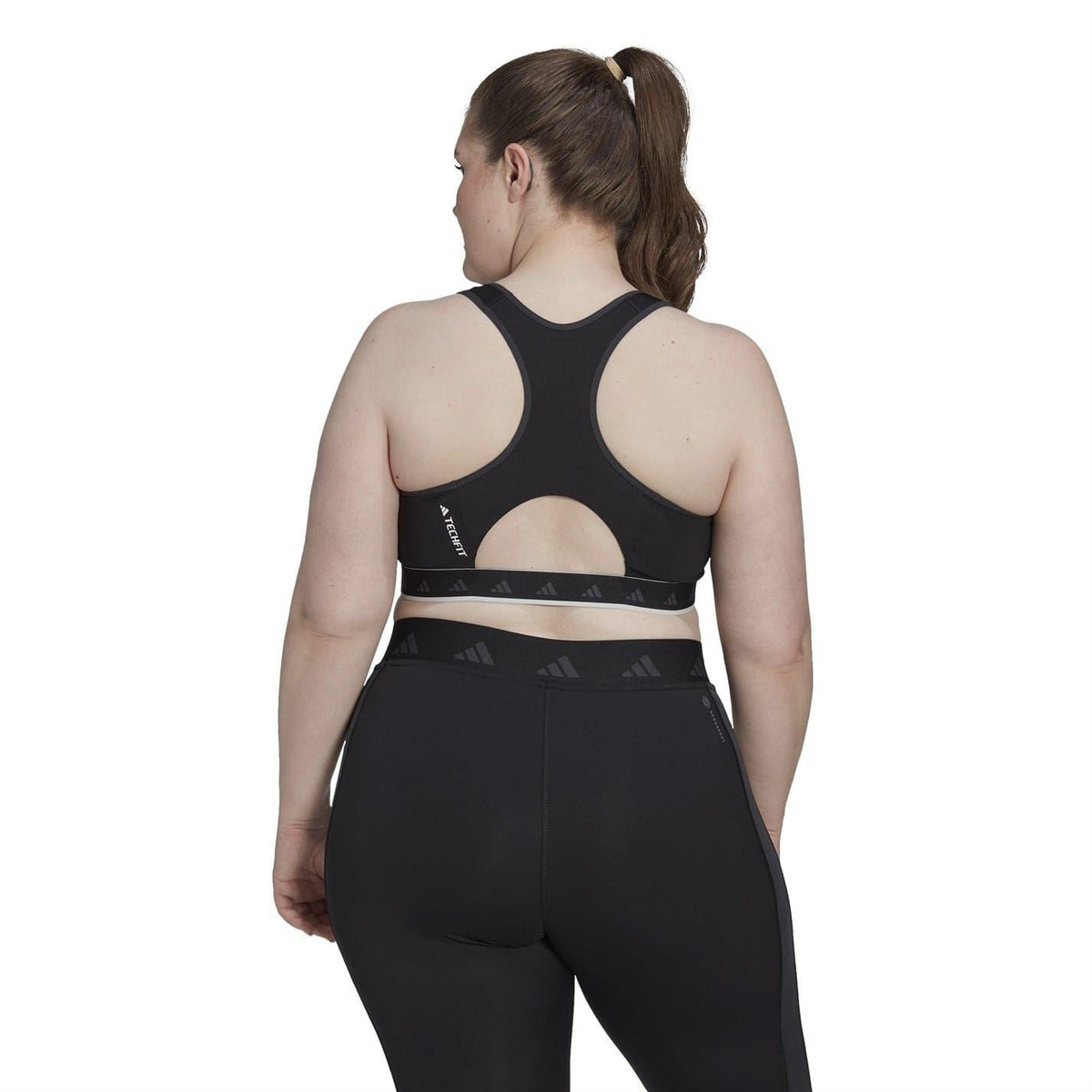 Black racerback sports bra top with open back and Adidas logo