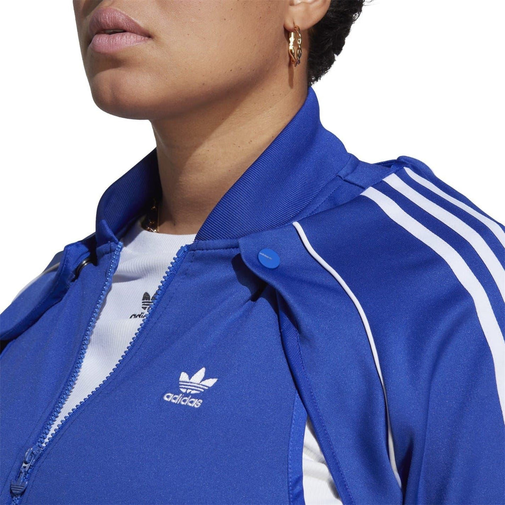 Blue adidas Originals track jacket collar close-up with white stripe trim