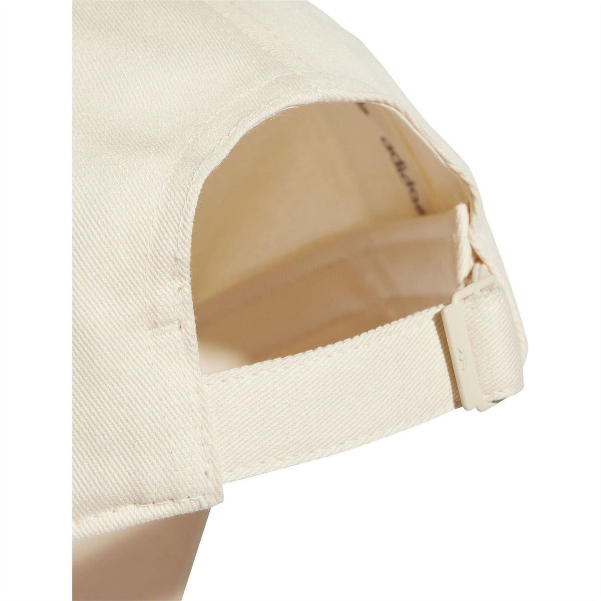 Light beige dad cap interior with adjustable fabric strap and curved opening