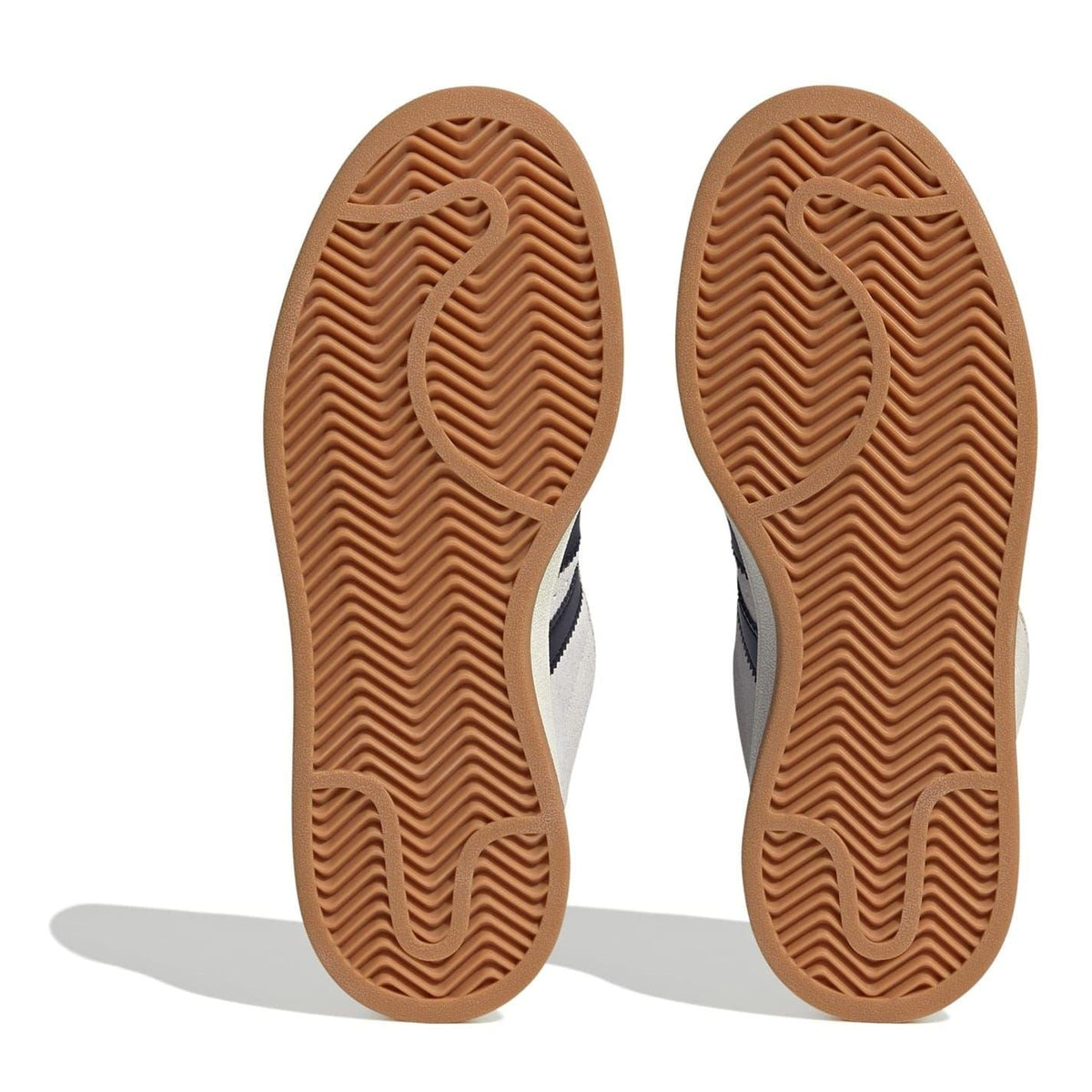 Gum rubber outsoles for light gray adidas low top sneakers with black stripe side panels