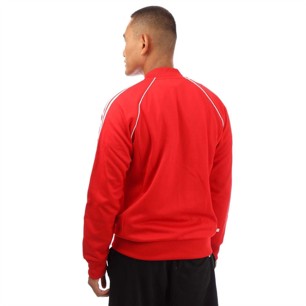 Red adidas track jacket back view with white piping and ribbed hem cuffs.