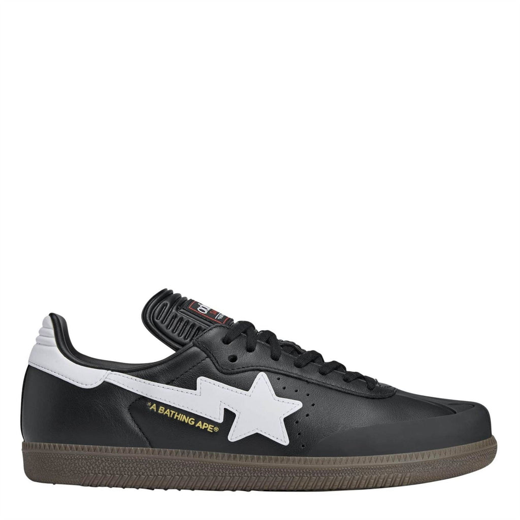 Black low-top canvas sneakers with white star logo and black lace-up design