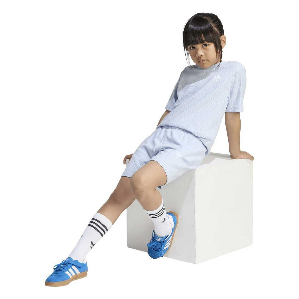 Juniors light blue loose T-shirt and shorts set worn, side view with drawstring shorts.