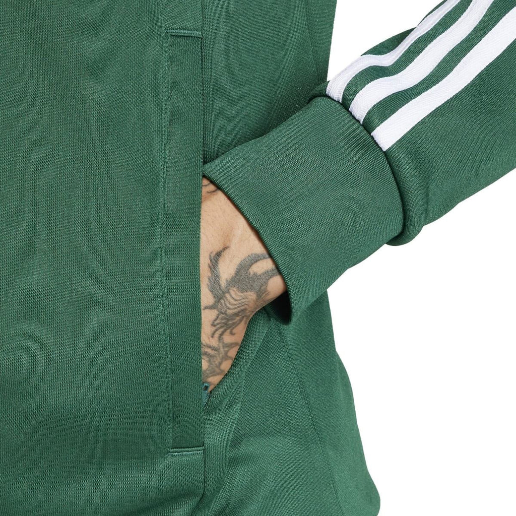 Green adidas track jacket close-up of zipper placket and ribbed sleeve cuff