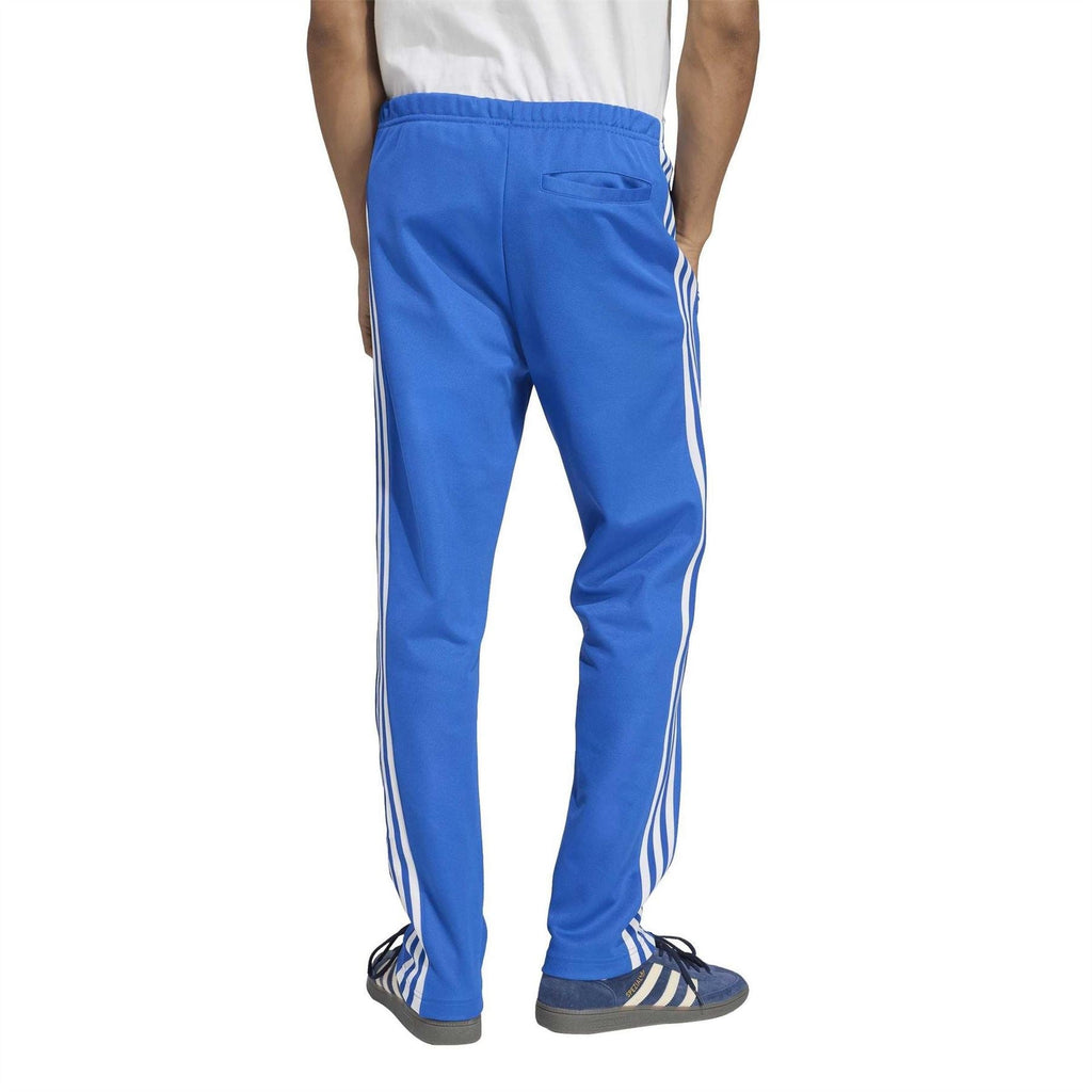 Blue track pants with white stripe seams, cuffed tapered fit and elastic waistband