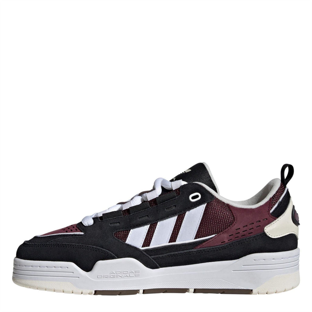 Kids' low-top trainers, side view, black with burgundy panels and white stripes