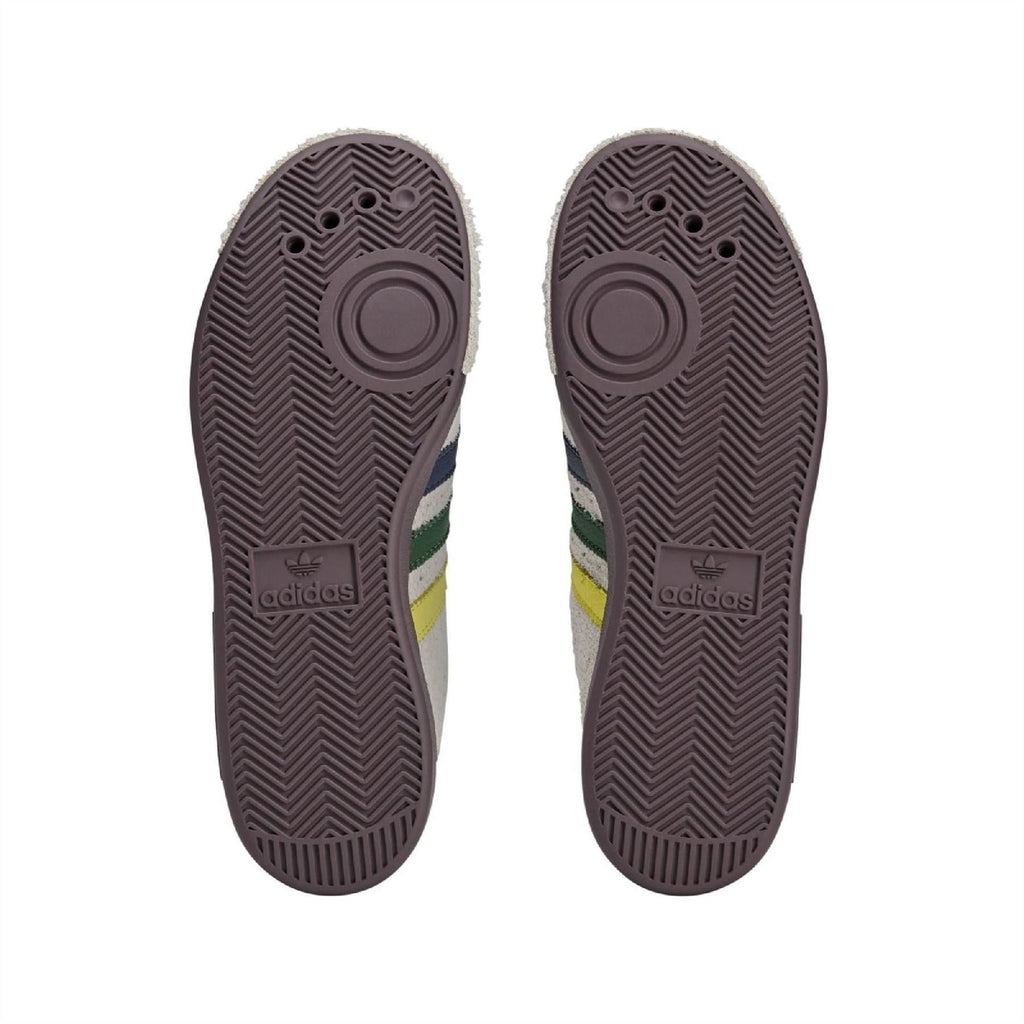 Brown rubber outsole for cream low-top sneakers with adidas logo and tread