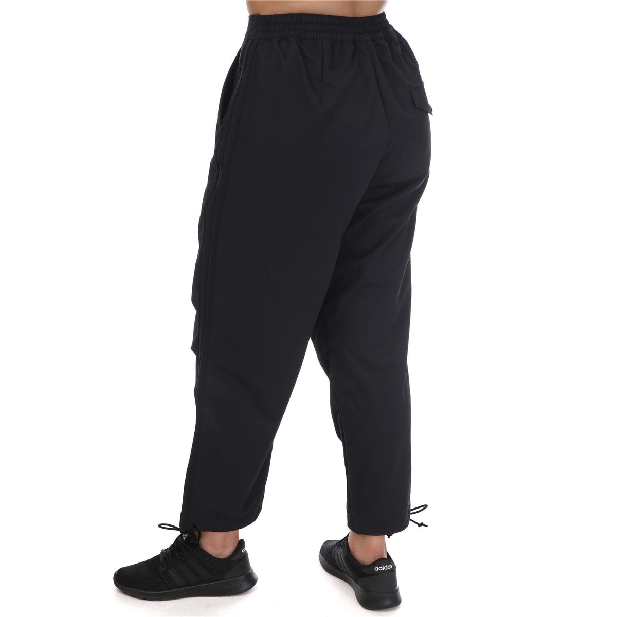 adidas Originals Adicolor Classic woven track pants showing navy blue fabric, elastic waistband, and side pockets.