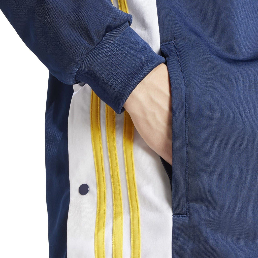 Dark blue track jacket sleeve with ribbed cuff and yellow stripe panel
