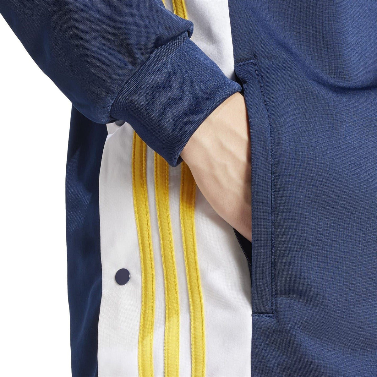 Dark blue track jacket sleeve with ribbed cuff and yellow stripe panel