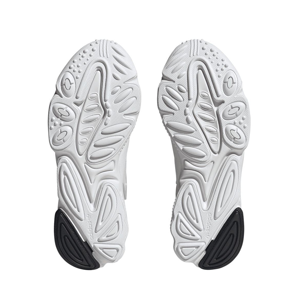 White adidas Originals Oztral trainers showing textured tread outsole with dark heel patch