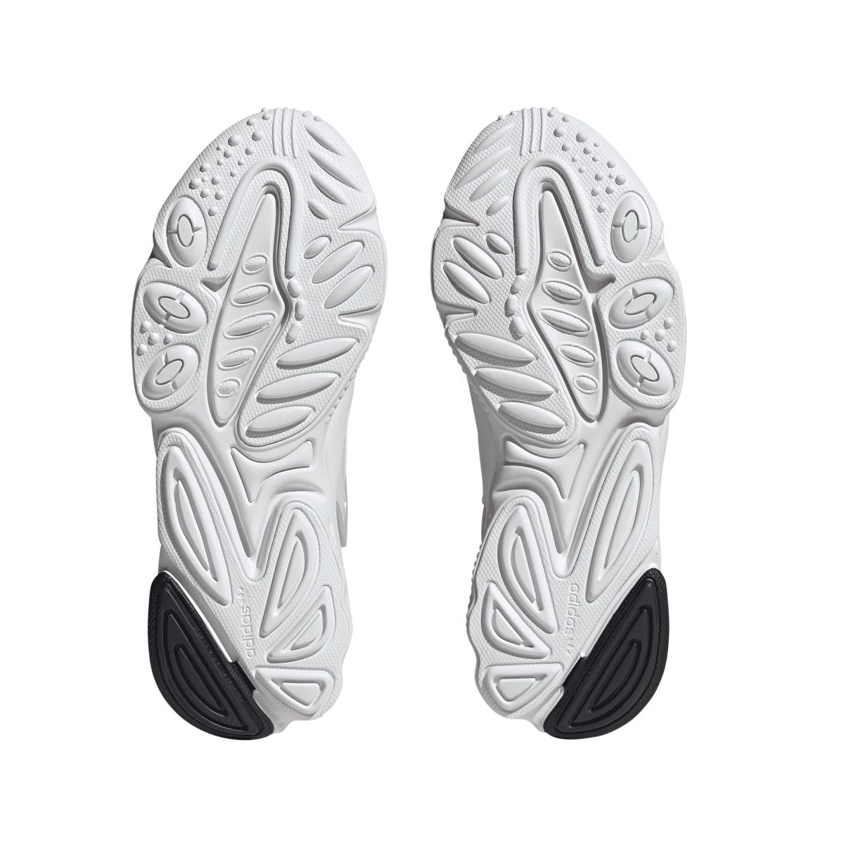 White adidas Originals Oztral trainers showing textured tread outsole with dark heel patch