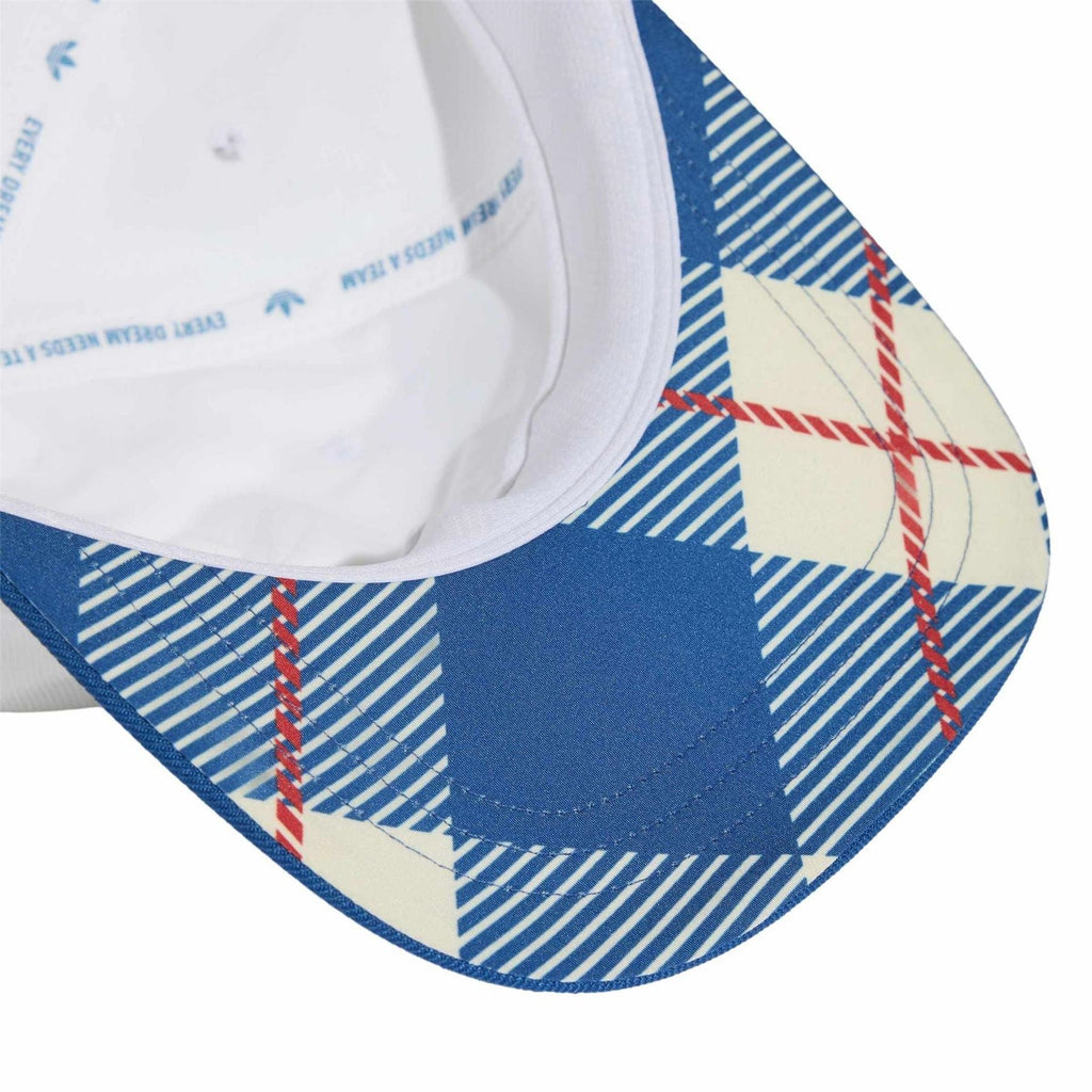 White snapback cap with blue patterned underbrim and adjustable snap strap