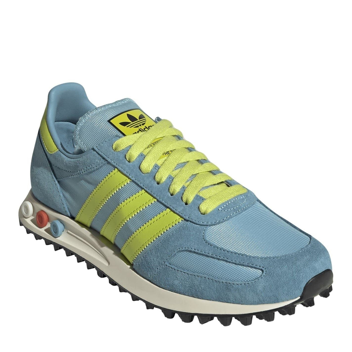 Blue lace-up sneakers with lime green stripes, yellow laces, Adidas logo on tongue