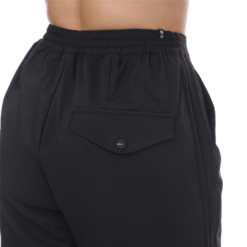 adidas Originals Adicolor Classic woven pants with a relaxed fit, featuring side pockets and tapered leg design.