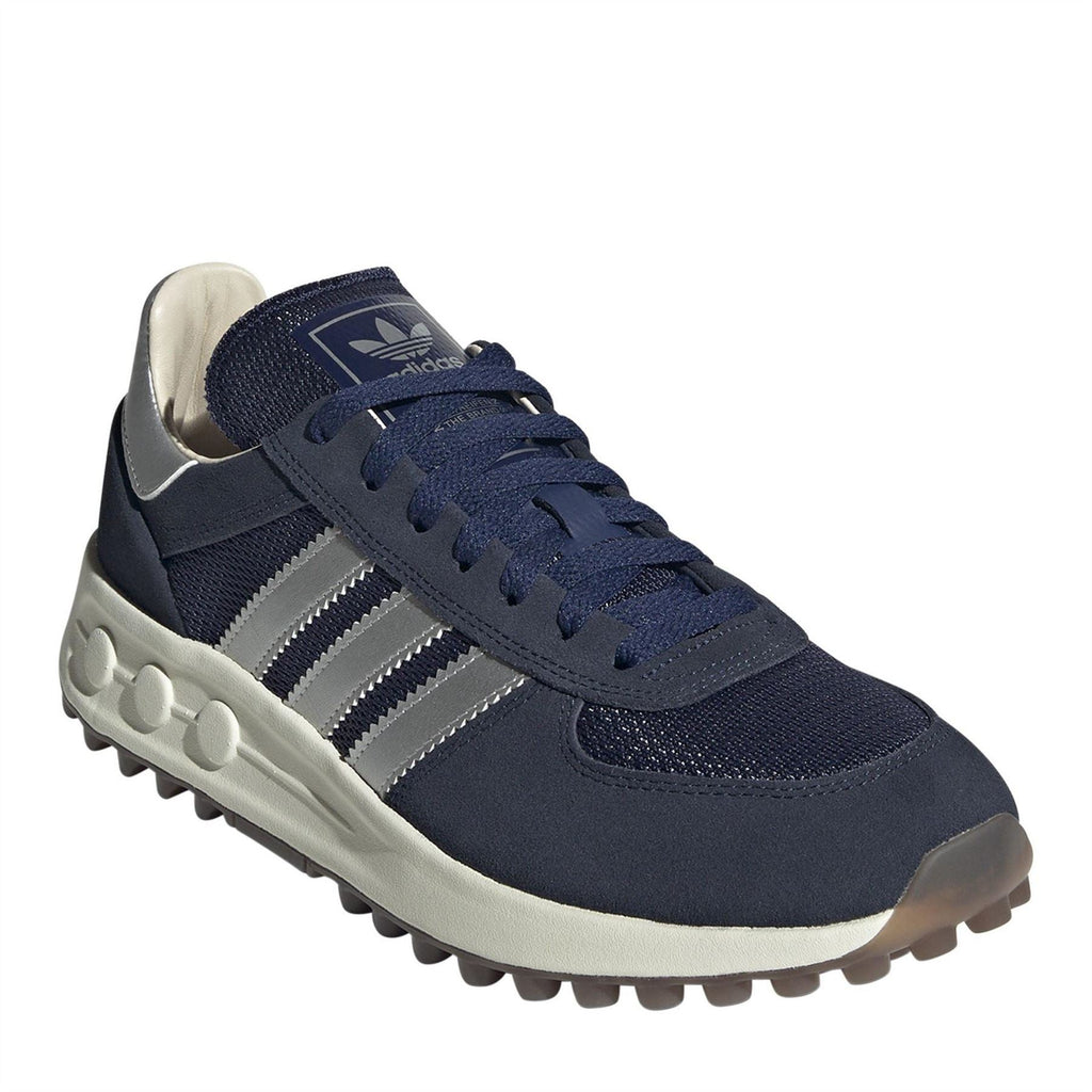 Indigo navy trainers with white stripes, lace-up front, and grippy textured outsole