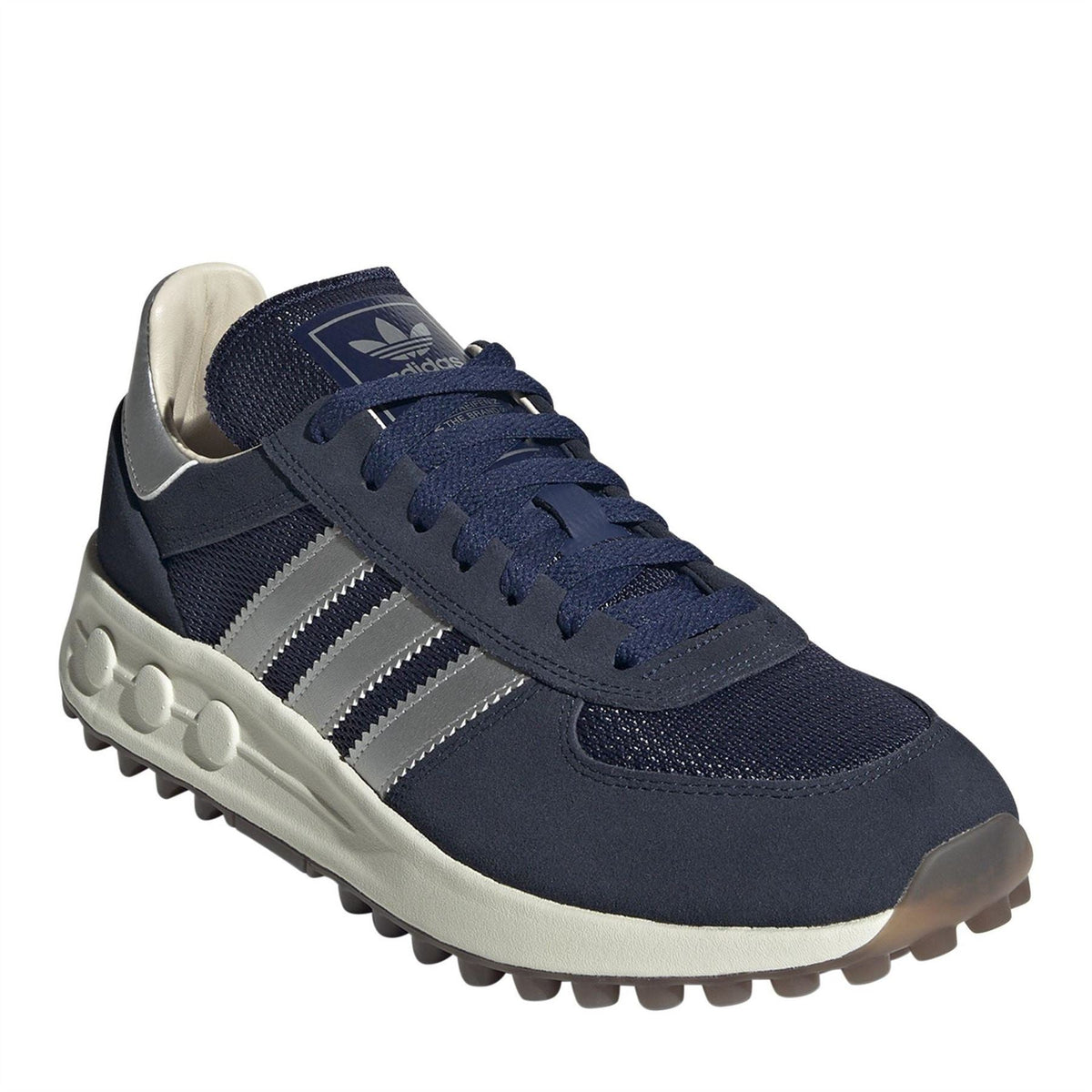 Indigo navy trainers with white stripes, lace-up front, and grippy textured outsole