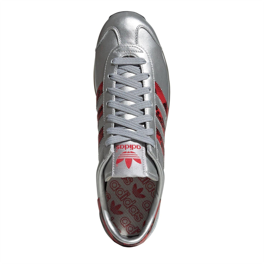 Silver adidas Originals sneaker with gray laces and red Trefoil logo on tongue