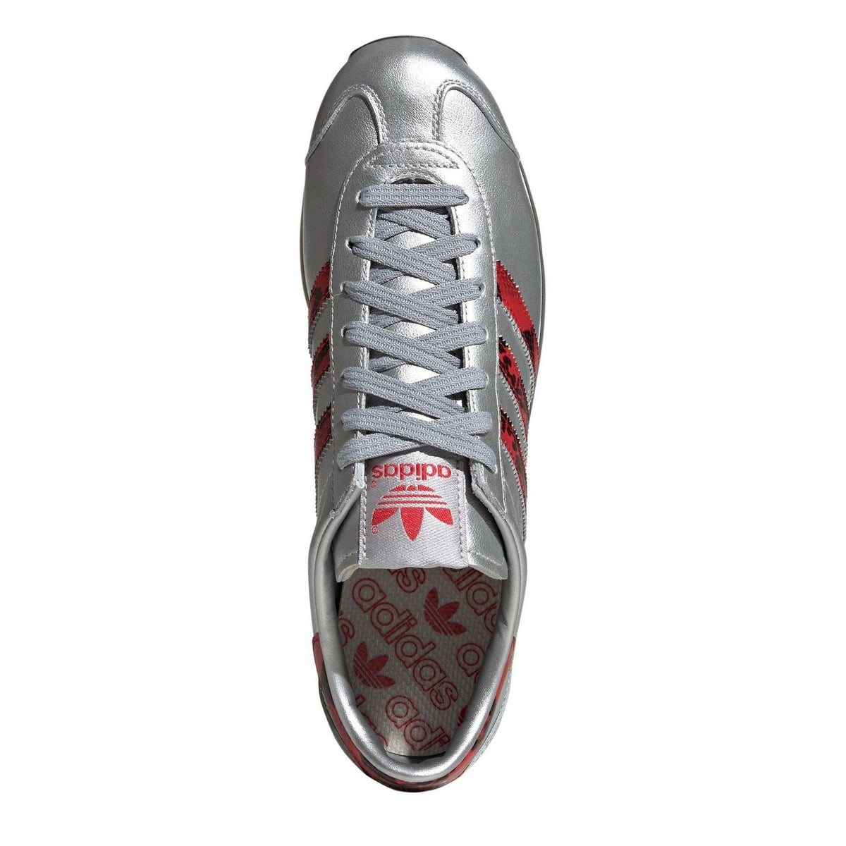 Silver adidas Originals sneaker with gray laces and red Trefoil logo on tongue