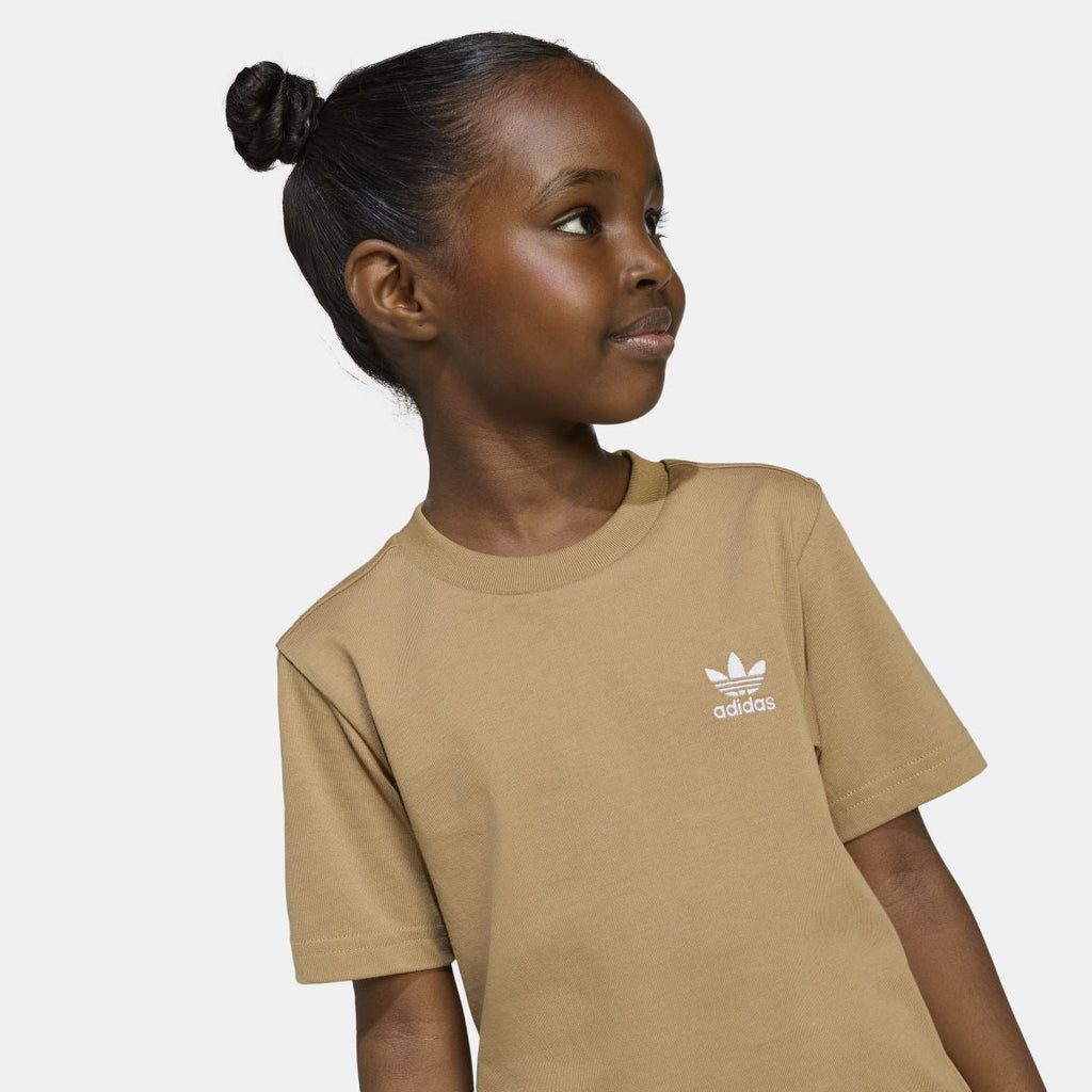 Tan adidas juniors T-shirt close-up on model; short sleeves with logo at chest